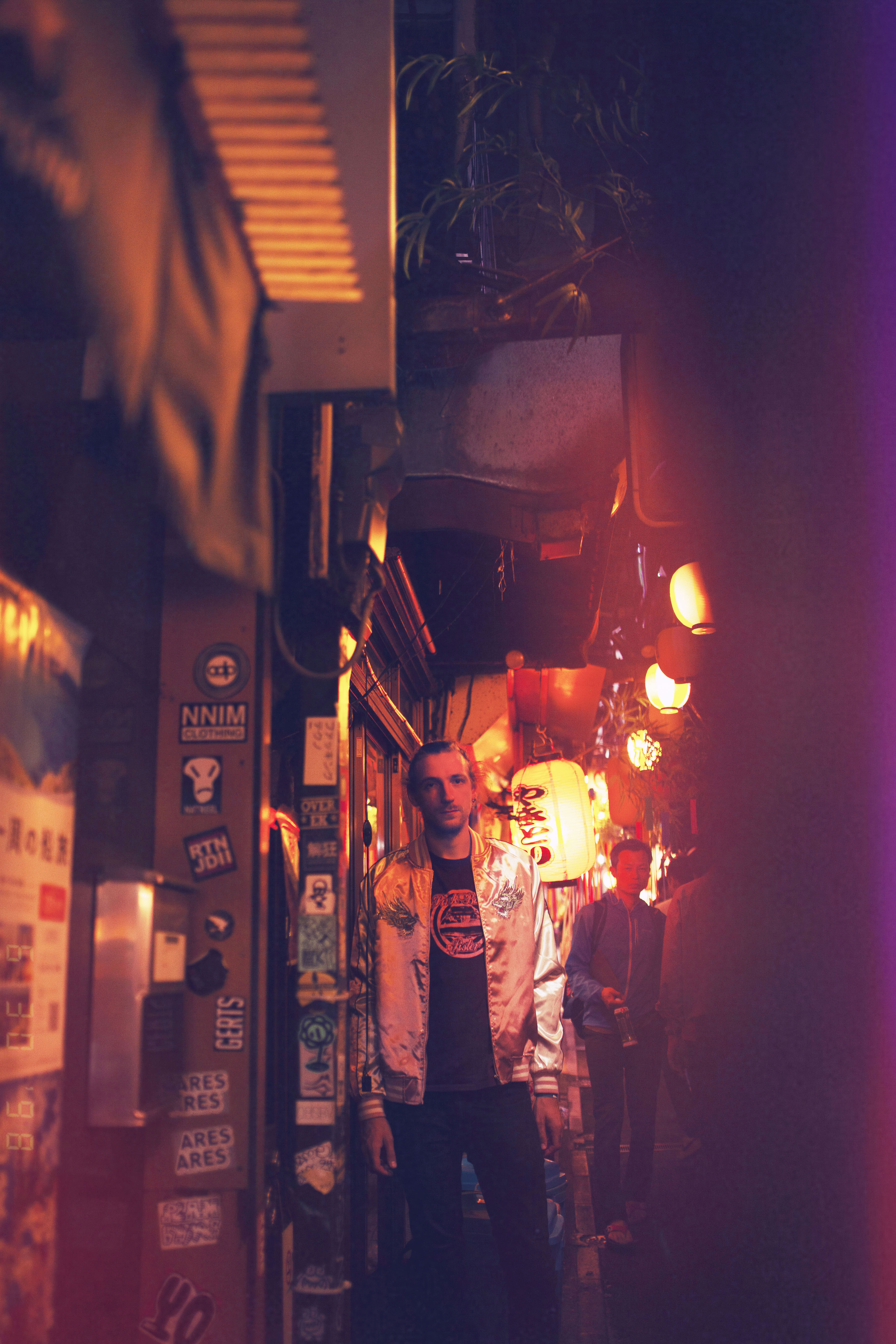 portrait d'un homme la nuit dans une rue japonaise